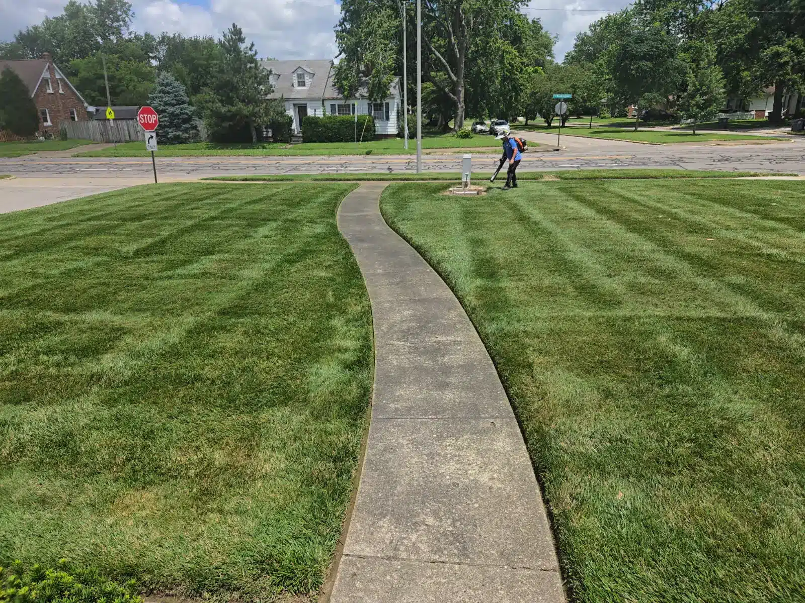 Yard with sidewalk after finished lawn care